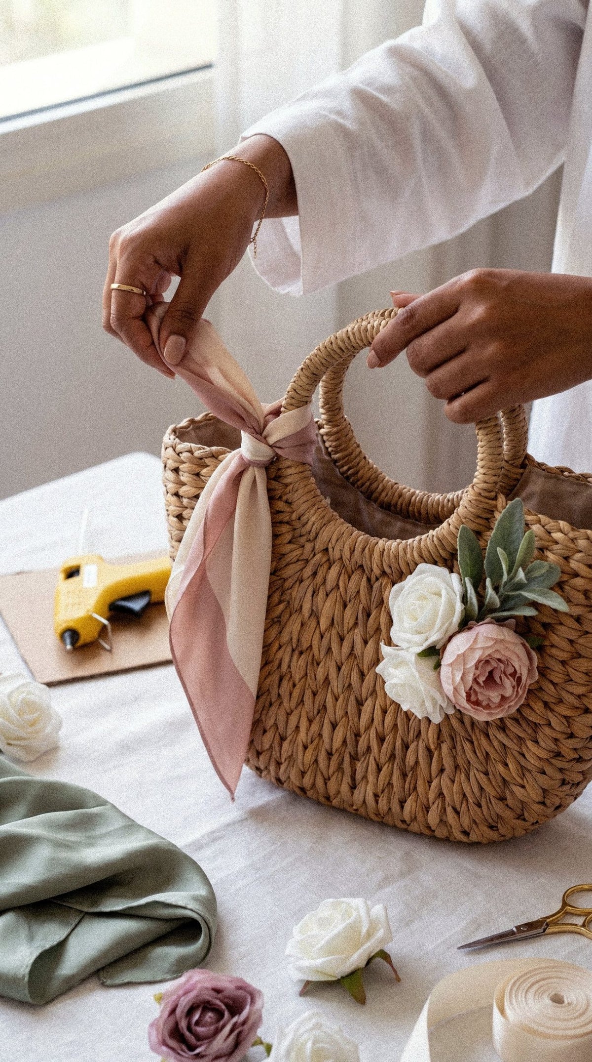 Tying a silk scarf onto a flower-trimmed basket